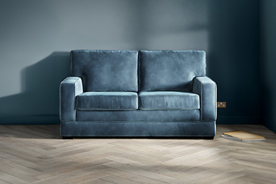 A blue Jay-Be® Urban sofa bed in a living room setup.